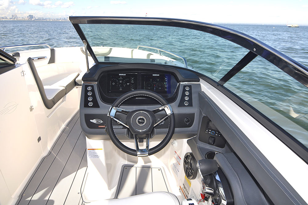 Starboard side helm with easy access to the bowrider from the cockpit and covered by a bimini top